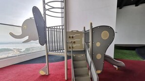 A children's play area with a slide and climbing structures, including a spiral and a climbing wall with letters. - Private Lift 5star Home Seaview Permas / Senibong Cove / Mid Valley Johor (Masai)