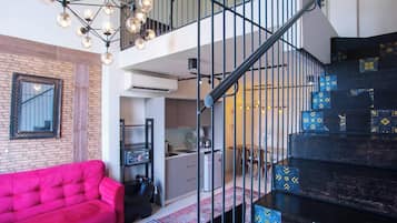 Deluxe Duplex, Balcony, City View | Living area | Flat-screen TV