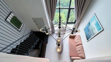 Deluxe Duplex, City View | Living area | Flat-screen TV