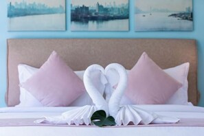 A bed with white pillows and a decorative swan towel arrangement. - Turquoise Villa 2 GYM and KIDS ROOM (Koh Samui)