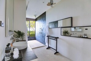 A modern bathroom with a large sink, a mirror, and a shower area. - Turquoise Villa 2 GYM and KIDS ROOM (Koh Samui)