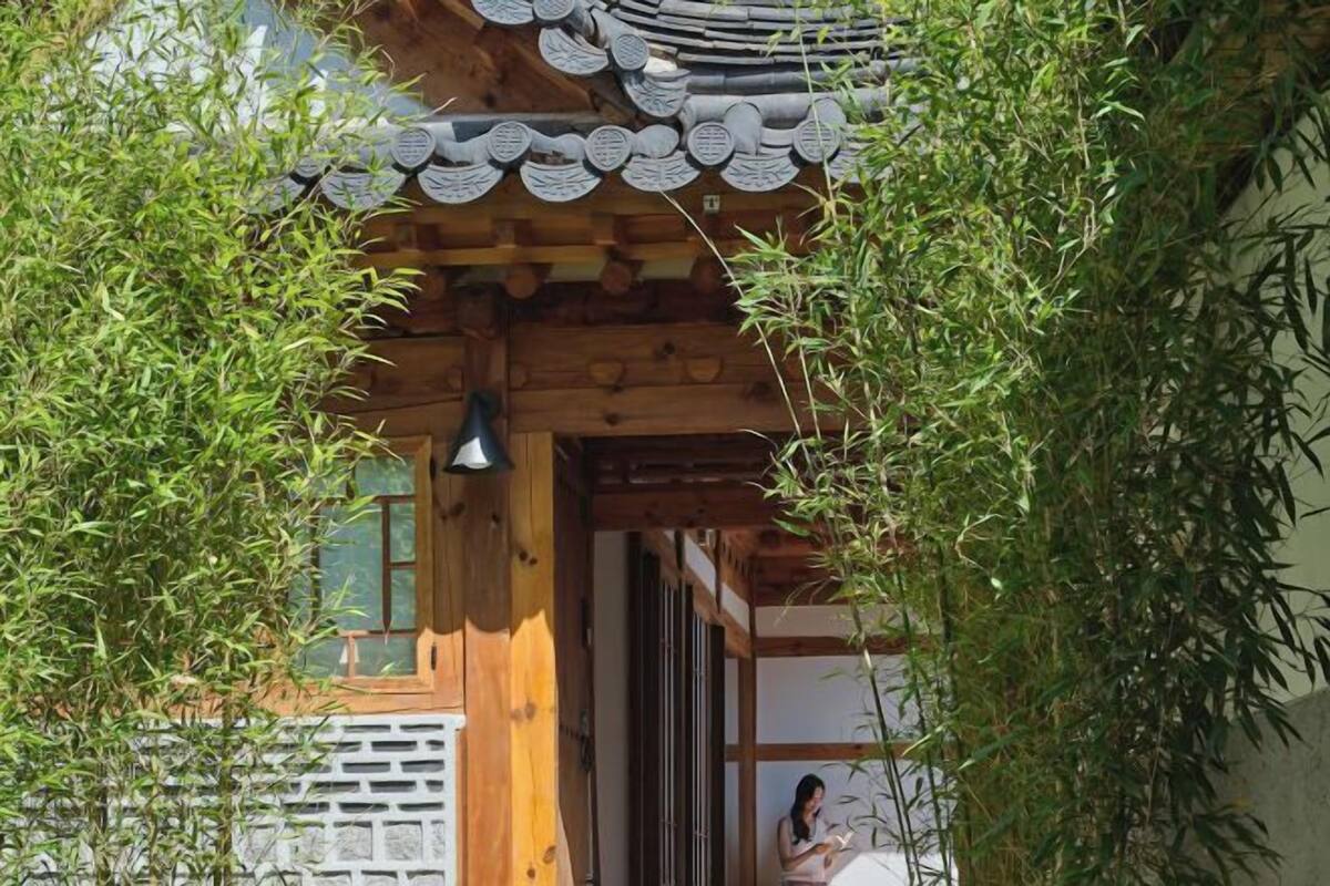 A traditional wooden building with a tiled roof and a wooden door.