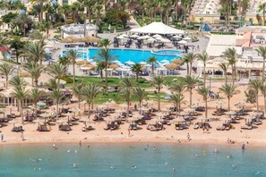 A resort with a beach, a pool area, and palm trees. - HRG Hurghada Aparthotel Aqua park A100 - By MAMO Property (Hurghada)