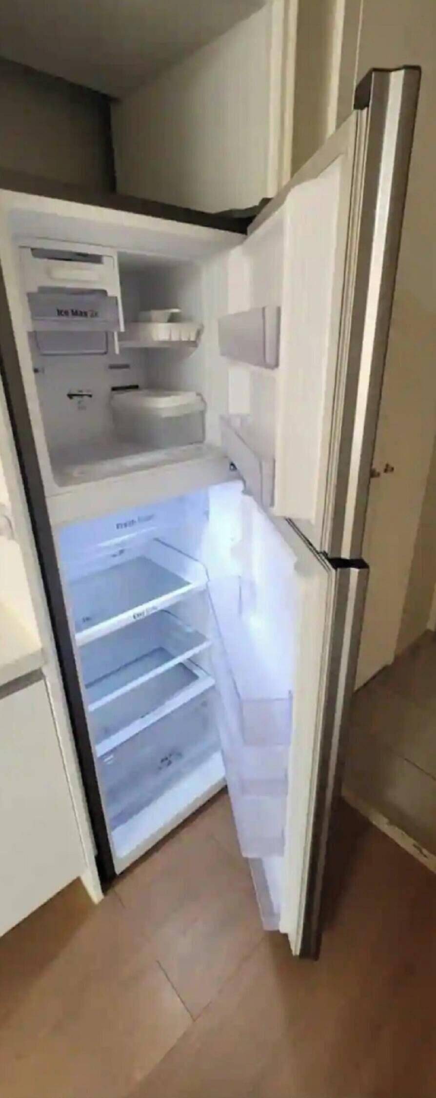 An open refrigerator with multiple shelves and a freezer compartment.