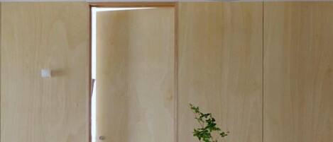 Una puerta de madera con una lámpara de techo blanca encima.