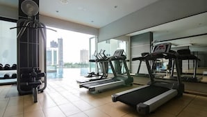 A gym with treadmills, a stationary bike, and a weight machine. - A Chic 3BR KSL DEsplanade Residence, FREE Parking (Johor Bahru)