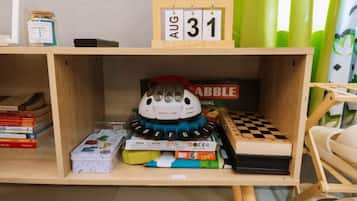 A shelf with a date sign, a plush toy, and various books.