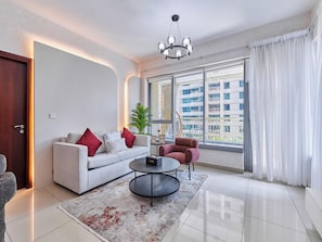 Premium Apartment, 1 Bedroom, Pool View | Living room | 55-inch Smart TV with cable channels - bnbme - 29 Boulevard Tower 1 - 1 BDR (Dubai)