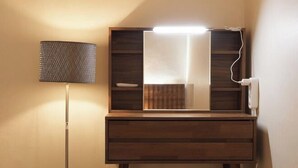 A wooden vanity with a mirror, a lamp, and a power outlet. - Sohwa Mansion [8min STN] / Luggage Keep available (Seoul)