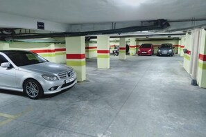 A multi-level parking garage with several cars parked. - Hassan II Mosque Casa International Fair (Casablanca)