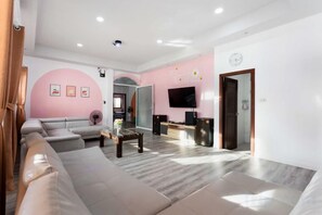 Una sala de estar moderna con un sofá, una mesa de centro y un televisor de pantalla plana.