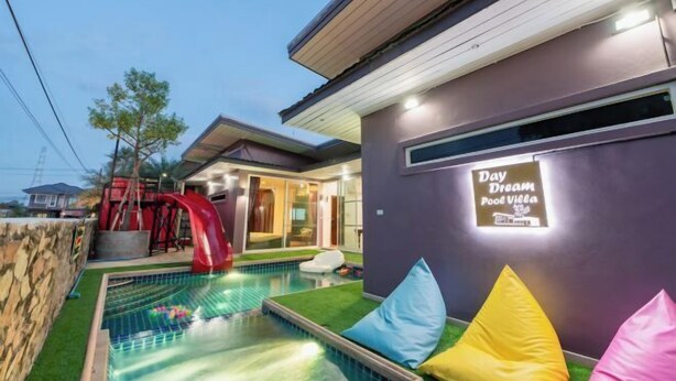 A modern pool area with a sign reading "Day Dream Pool Villa". - DayDream Pool Villa (Bang Lamung)