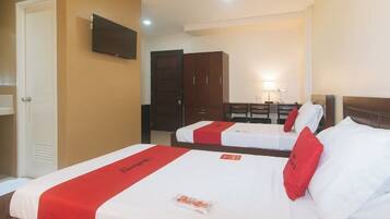 A hotel room with two beds, a television, a desk with a chair, and a wardrobe.