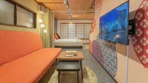 A hotel room with a wooden ceiling, a sofa, a bed, a small table, and a TV mounted on the wall. - STAY OSAKA KUROMON Walkable to Namba, Shinsaibashi, and Dotonbori 14-minute train ride to USJ (Osaka)