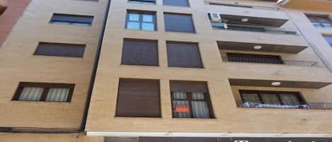 A multi-story building with a storefront labeled 'Tentazioni.'