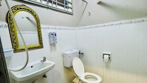A bathroom with a white sink, toilet, and mirror with a decorative frame. - Relax Familystay usm 3BR 2-6 pax (Gelugor)