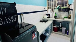 A compact kitchen with a coffee machine, a sink, and a window with a grid pattern. - Relax Familystay usm 3BR 2-6 pax (Gelugor)