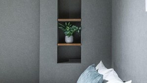 A wall with three wooden shelves, one of which holds a potted plant. - Travel time Momotani - 9min walk to Tōgaku Station, 18min walk to Shitennoji Temple (Osaka)
