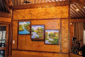 A room with wooden paneling and two landscape paintings on the wall. - Sinai Bungalow & Hotel SaPa (Sapa)