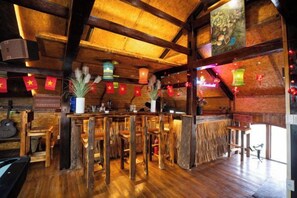 A rustic interior with wooden beams, a bar area, and traditional decor. - Sinai Bungalow & Hotel SaPa (Sapa)
