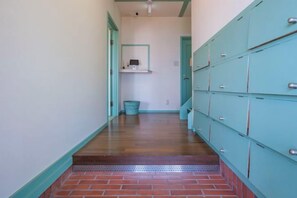 A hallway with lockers, a trash bin, and a shelf with a mirror. - NOSTALGIA NASA (Kaiyo)
