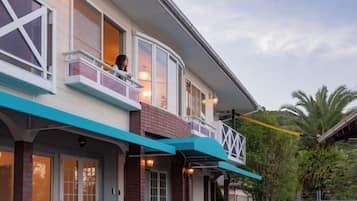 A two-story building with a balcony on the upper floor.
