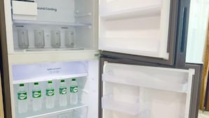 An open refrigerator with a 'Ground Cooling' label, multiple shelves, and a 'Optimal Fresh' label. - The White House Kamala Phuket (Phuket)