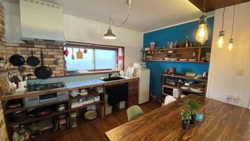 A compact kitchen with a wooden countertop, a built-in stove, and a window with a view.