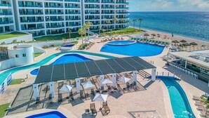 A resort with multiple swimming pools, a beach, and a large hotel building. - Esmeralda Beach Resort 3 Bedrooms C 703 (Puerto Peñasco)