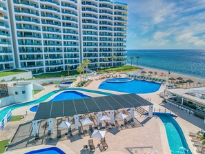A resort with multiple swimming pools, a beach, and a large hotel building. - Esmeralda Beach Resort 3 Bedrooms C 703 (Puerto Peñasco)