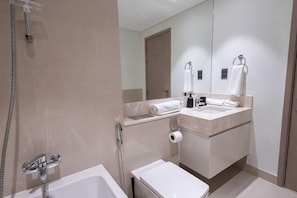 A modern bathroom with a bathtub, a sink, and a mirror. - MH- Act – Downtown 1BHK-REF4006 (Dubai)