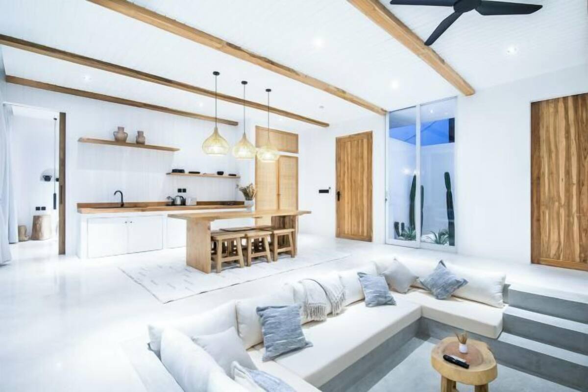 A modern living space with a kitchen, dining area, and seating area.