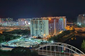 A multi-story building with a flat roof, surrounded by a construction site and a bridge. - Sutera Bay Luxe Haven Suite Infini Stay (Kota Kinabalu)
