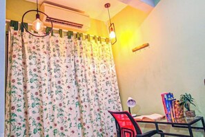 A room with a bed, a desk with a chair, a potted plant, and a window with curtains. - Lovely Garden Home BBQ Event at Klang by HCK (Klang District)
