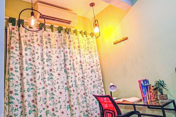 A room with a bed, a desk with a chair, a potted plant, and a window with curtains. - Lovely Garden Home BBQ Event at Klang by HCK (Klang District)