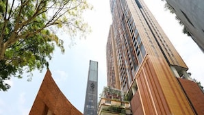 A tall building with a modern design, featuring multiple balconies with greenery. - Lucentia Residence at Kuala Lumpur by Dreamcloud Sdn Bhd (Kuala Lumpur)