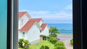 A view of a residential area with houses and a road leading to the sea. - Tebaz (Jeju)