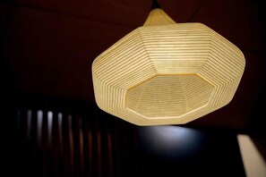A geometric pendant light fixture with a hexagonal shape and a honeycomb pattern. - INN Plus Hanamidou (Kyoto)