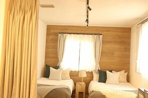 A hotel room with two beds, wooden headboard, curtains, a nightstand, and a lamp. - [TV] Luxury adult secret base villa 120 ㎡ Sauna, stone bath, bonfire, BBQ [Mori building] (Miyota)