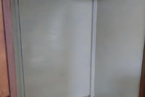 A room with a large window, a wooden door, and a white wall. - Traditional Inn (Tokyo)