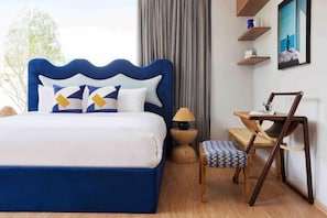 A bedroom with a large bed, bedside tables, a chair, a desk, and a window with curtains. - Prime Beach House No. V7 (Sattahip)