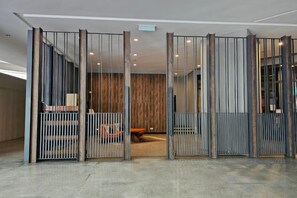 A modern interior with a partitioned seating area, a wooden wall, and a carpeted floor.