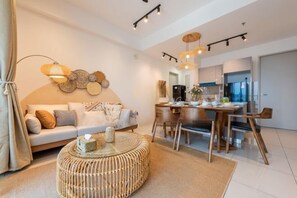 A modern living room with a sofa, a dining table, and a coffee table.