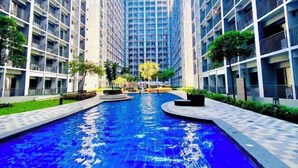 A modern building with a central courtyard featuring a reflective pool. - Ai-Stay 78 at Shore 2 T1 (Pasay)