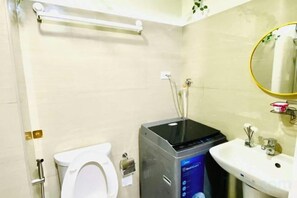 A bathroom with a toilet, a sink, and a shower unit. - Ai-Stay 78 at Shore 2 T1 (Pasay)