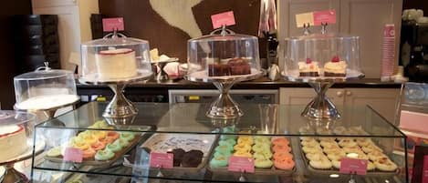 A bakery display with various pastries and cakes.
