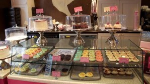 A bakery display with various pastries and cakes.