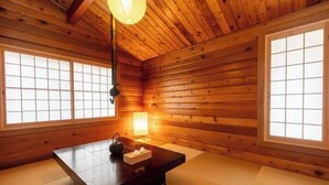 A traditional Japanese room with tatami flooring, a wooden ceiling, and sliding shoji doors. - SHODOSHIMA PRIVATE CAMP SITE (Shodoshima)