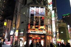 A multi-story building with illuminated signage, including a prominent number '2,980' and a restaurant sign. - Kinshicho 1001 (Tokyo)