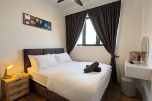 A hotel room with a bed, bedside lamp, and a window with curtains. - M Vertica KL City 4 Bedroom Fully Air-Con Suite (Kuala Lumpur)